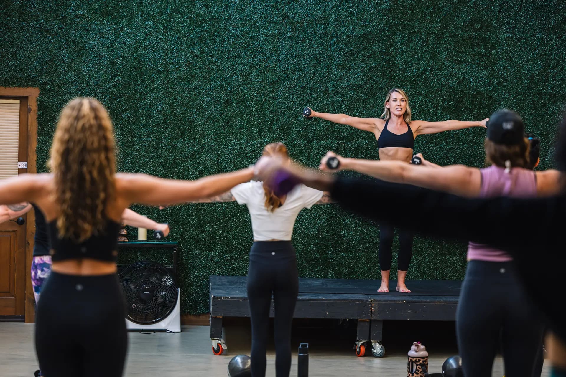 Chelsea leading a group class with hand weights